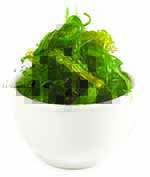 Seaweed salad garnished in white bowl.